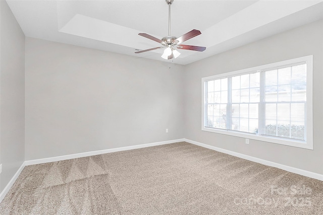 unfurnished room featuring a ceiling fan, baseboards, and carpet flooring