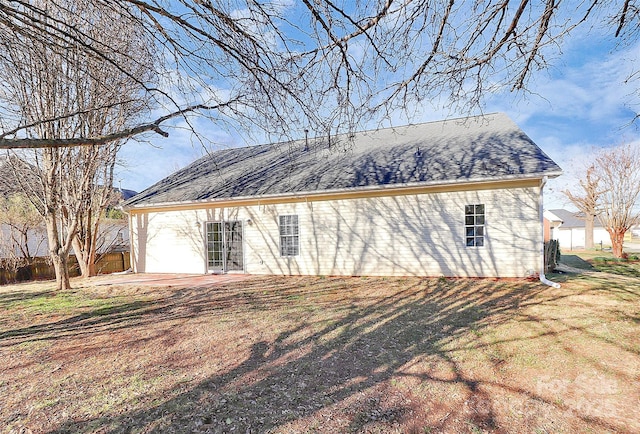 view of side of home with roof with shingles