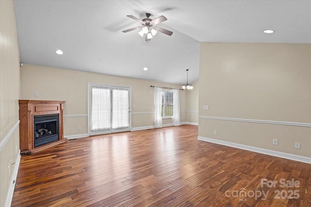 unfurnished living room with ceiling fan with notable chandelier, wood-type flooring, and lofted ceiling