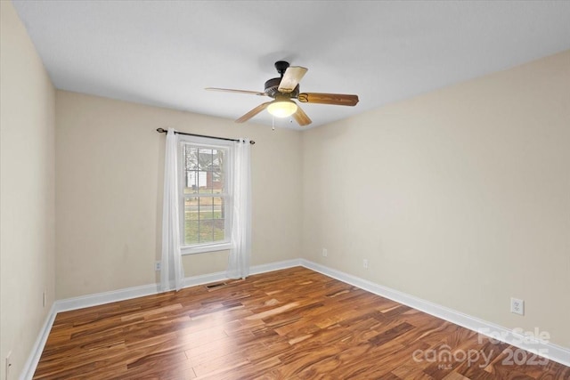 empty room featuring wood-type flooring and ceiling fan