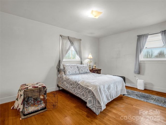 bedroom with hardwood / wood-style flooring