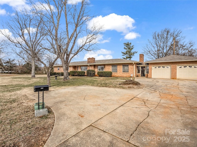 ranch-style house with a garage and a front lawn