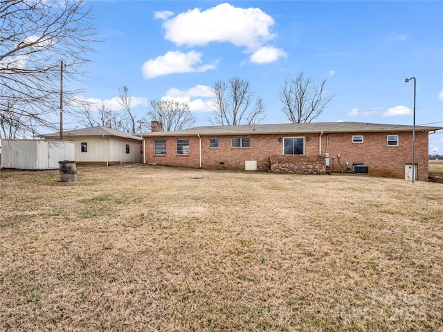 back of house featuring central AC and a yard