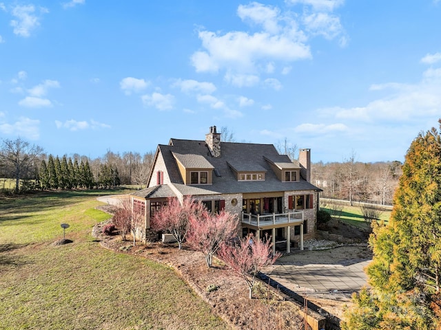 rear view of house featuring a yard