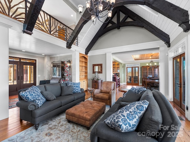 living room featuring a notable chandelier, french doors, and hardwood / wood-style floors