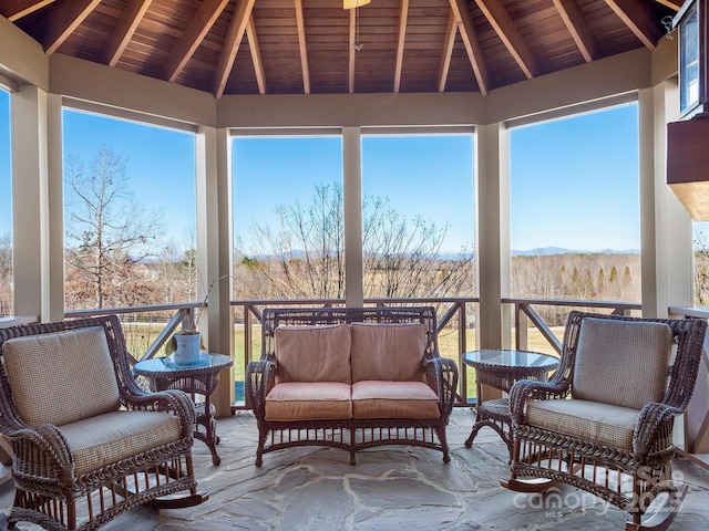 sunroom / solarium featuring wooden ceiling, a wealth of natural light, and vaulted ceiling with beams