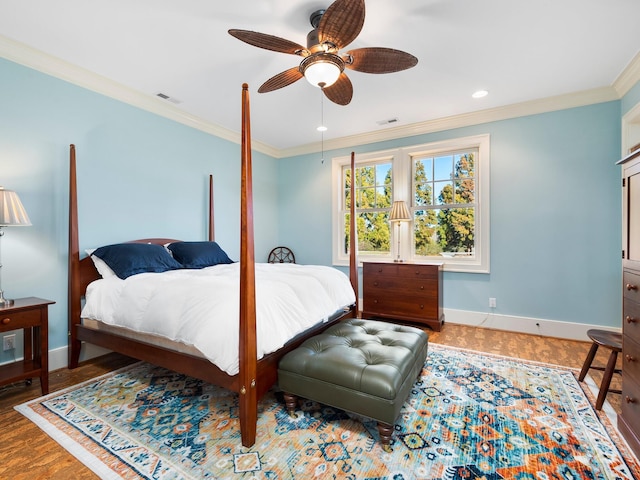 bedroom with ornamental molding, ceiling fan, and hardwood / wood-style flooring