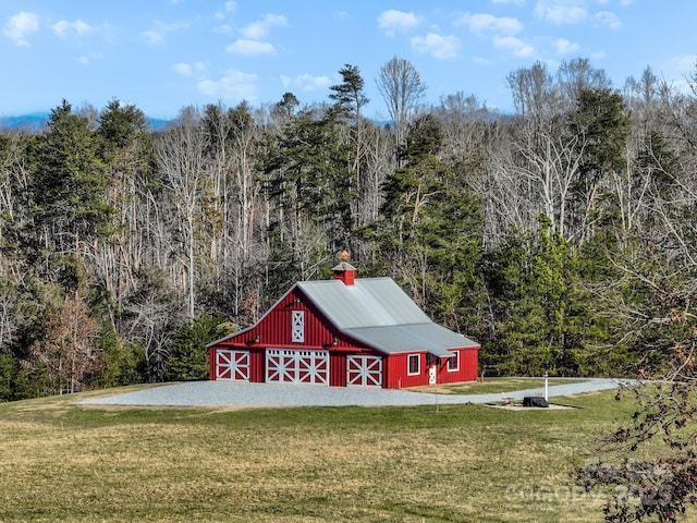 view of outbuilding with a yard