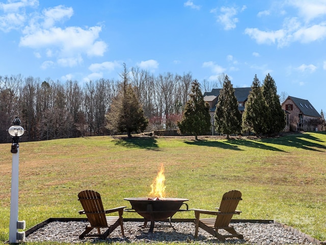 view of yard with an outdoor fire pit