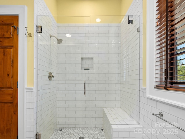 bathroom featuring a shower with shower door