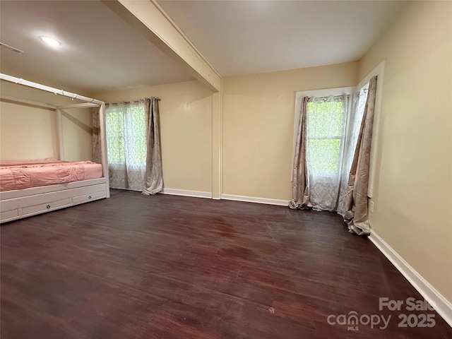 3465 Peniel Rd, Tryon, NC 28782 - unfurnished bedroom featuring dark wood-type flooring and baseboards