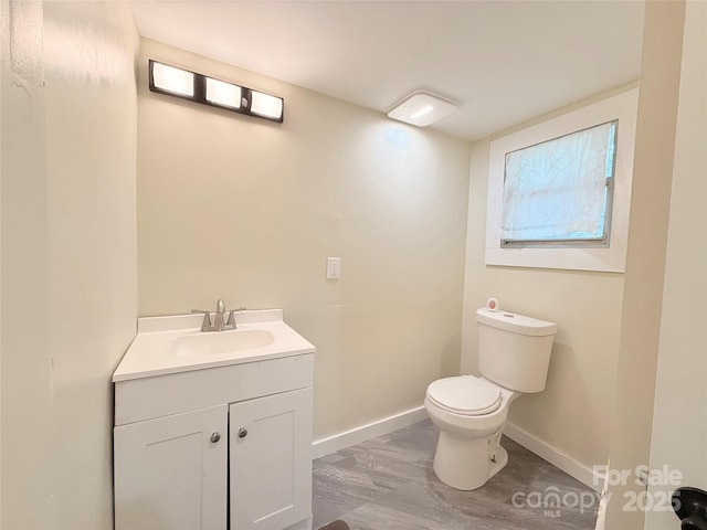 3465 Peniel Rd, Tryon, NC 28782 - bathroom featuring toilet, baseboards, vanity, and wood finished floors