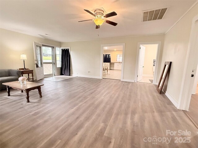3465 Peniel Rd, Tryon, NC 28782 - unfurnished living room featuring light wood-type flooring, ceiling fan, and baseboards