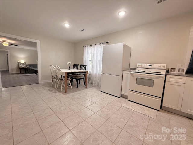 3465 Peniel Rd, Tryon, NC 28782 - kitchen with white appliances, light tile patterned flooring, recessed lighting, and white cabinetry