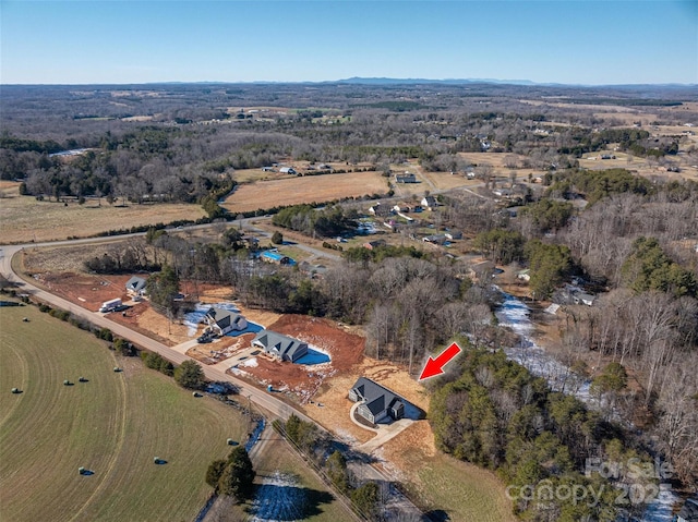 birds eye view of property featuring a rural view