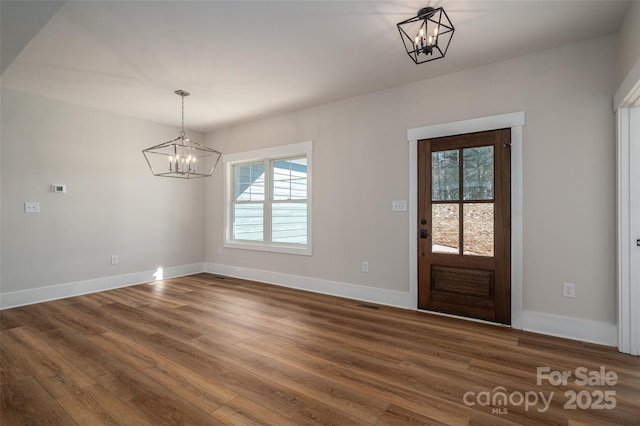 foyer featuring hardwood / wood-style floors and a chandelier