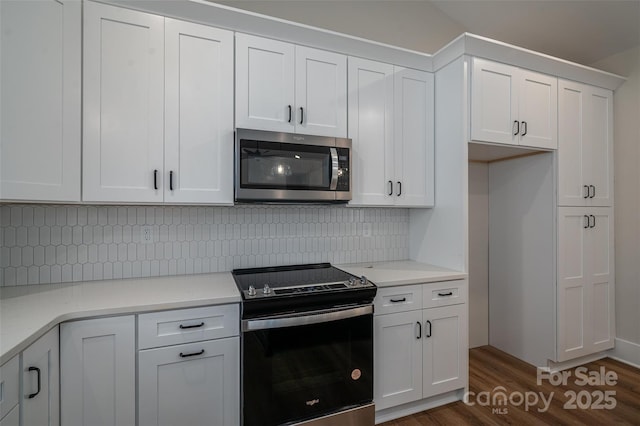 kitchen featuring white cabinets, electric stove, tasteful backsplash, and dark hardwood / wood-style floors