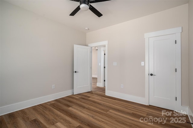 unfurnished bedroom featuring hardwood / wood-style floors and ceiling fan