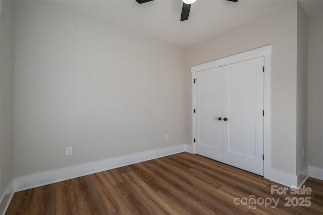 unfurnished bedroom featuring hardwood / wood-style flooring, ceiling fan, and a closet