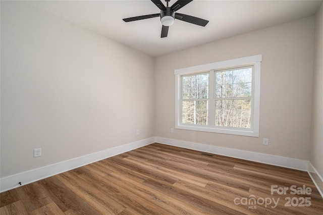 spare room with ceiling fan and wood-type flooring