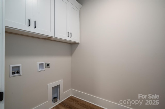 laundry area featuring electric dryer hookup, hookup for a washing machine, cabinets, and dark hardwood / wood-style flooring