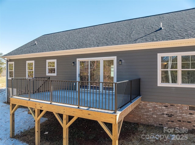 back of property featuring a wooden deck