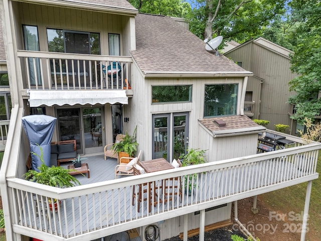 back of house featuring a deck