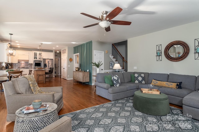 living room with ceiling fan and wood-type flooring