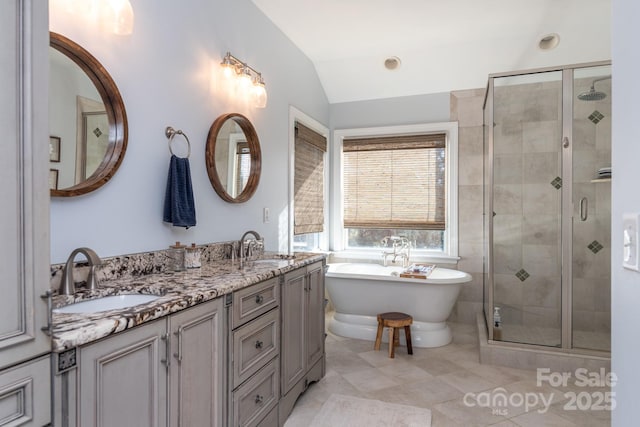 bathroom featuring vanity, vaulted ceiling, and plus walk in shower