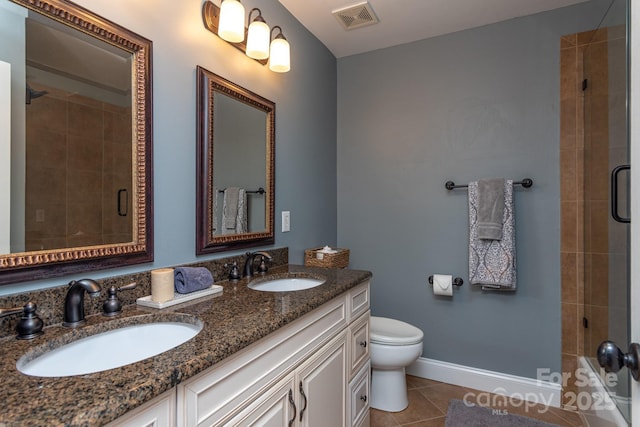 bathroom with toilet, a shower with door, tile patterned flooring, and vanity