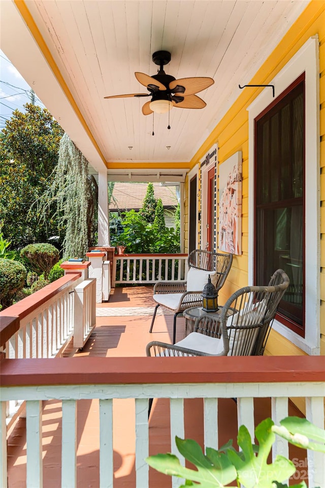 wooden deck with ceiling fan and a porch