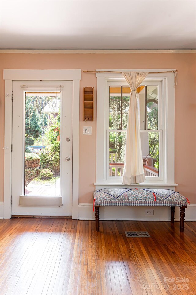 doorway with hardwood / wood-style flooring