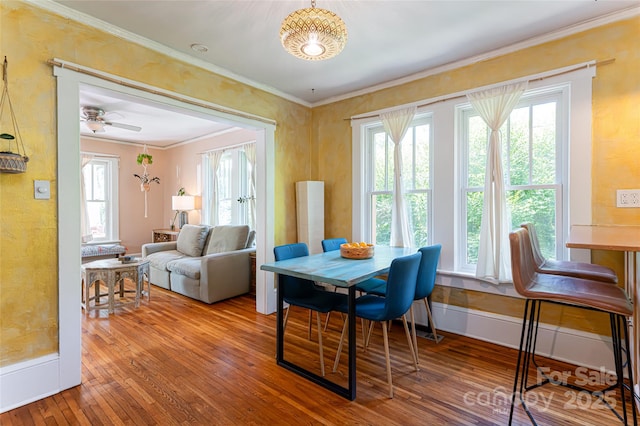 dining space with ceiling fan, ornamental molding, and hardwood / wood-style floors