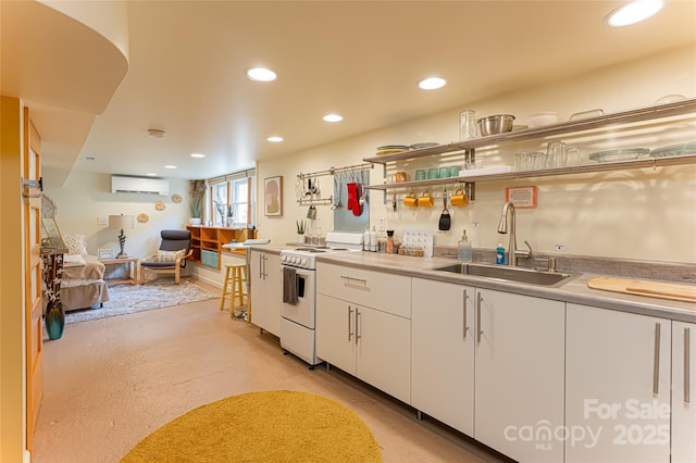 kitchen featuring electric stove, white cabinetry, sink, and a wall mounted air conditioner