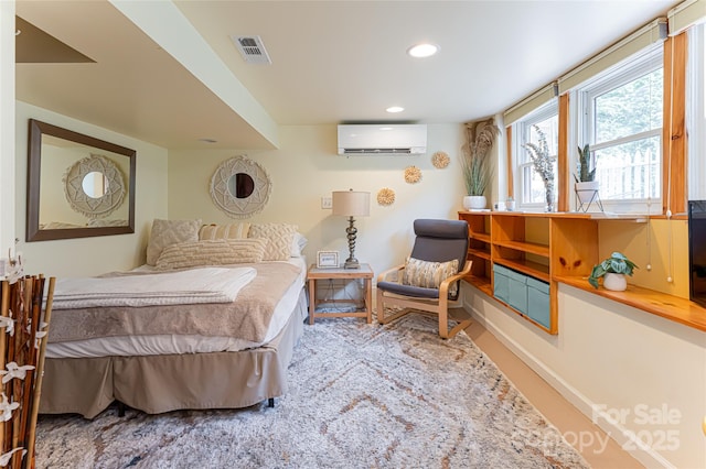 bedroom with an AC wall unit
