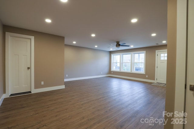 empty room with ceiling fan and dark hardwood / wood-style floors