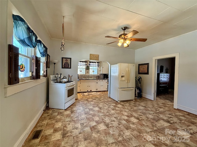 kitchen with decorative backsplash, ceiling fan, white cabinets, and white appliances