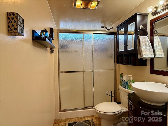 bathroom with tile patterned floors, vanity, toilet, and an enclosed shower