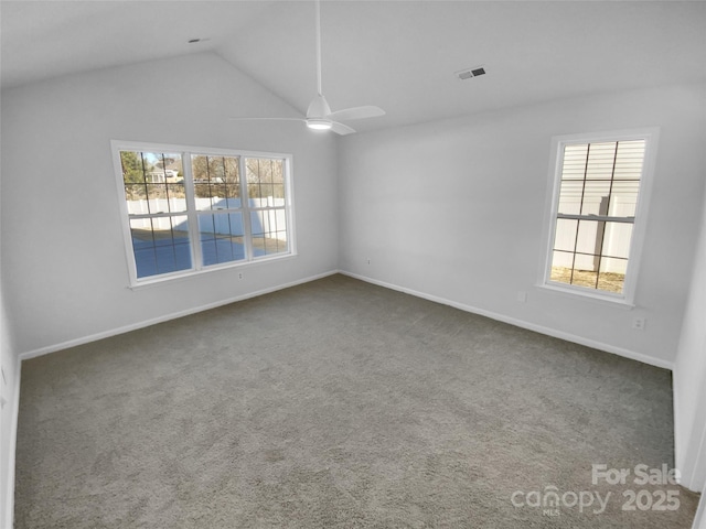 carpeted empty room featuring ceiling fan and lofted ceiling