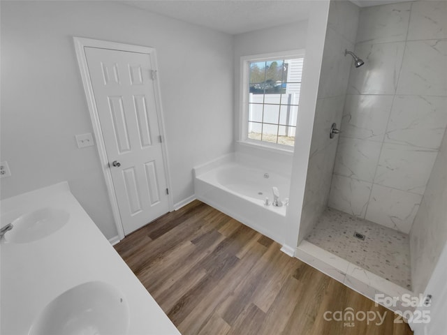 bathroom featuring vanity, independent shower and bath, and hardwood / wood-style flooring