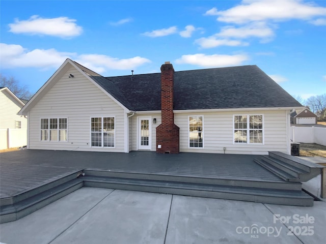 rear view of property featuring a deck