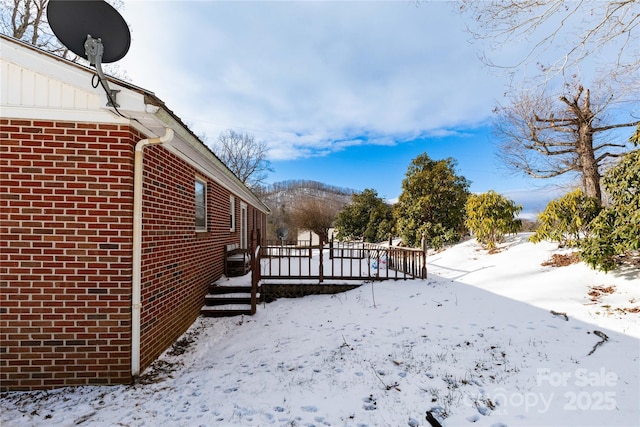 yard layered in snow with a deck