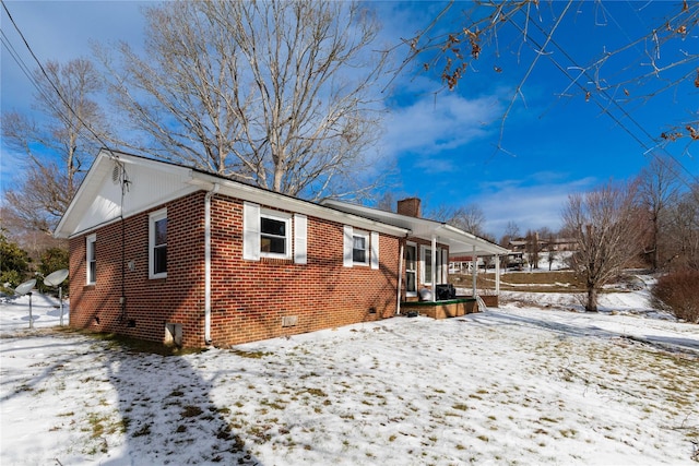 snow covered property featuring covered porch