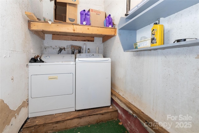 clothes washing area featuring separate washer and dryer