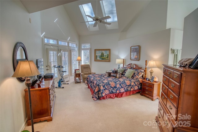 carpeted bedroom with ceiling fan and high vaulted ceiling