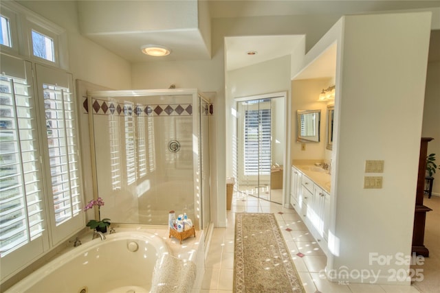 bathroom featuring vanity, plenty of natural light, tile patterned floors, and shower with separate bathtub