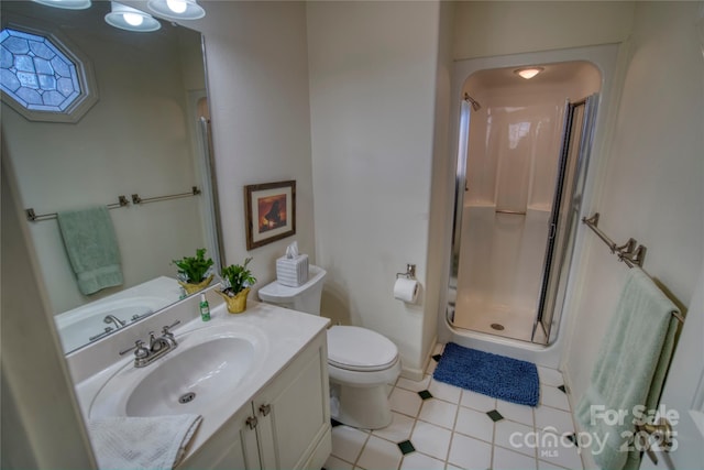 bathroom with toilet, tile patterned floors, vanity, and an enclosed shower