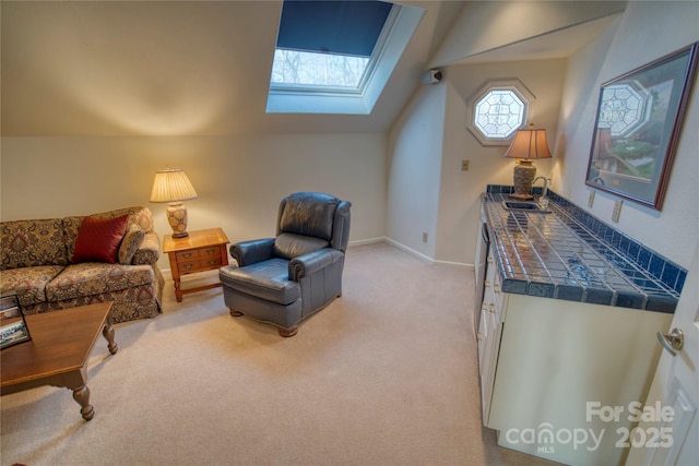 living area with sink, lofted ceiling with skylight, and light carpet