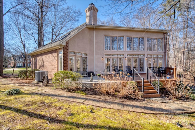 rear view of house featuring a deck and cooling unit