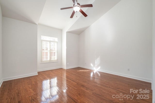 spare room with ceiling fan, lofted ceiling, and wood-type flooring